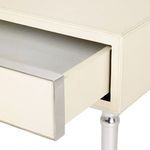 Drawer partially open revealing smooth interior and polished nickel front edge