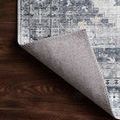 Close-up of Skye Silver/Grey Rug corner turned up showing stitched edging and low pile back