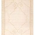 Beige and cream hand knotted rug with an open center medallion, textured border and matching fringe