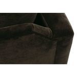 Low-angle close-up of chair’s base and upholstered seat edge with a dark wooden platform