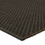 Close-up of Sena rug corner showing tight handwoven weave and diagonal brown stripe texture