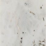 Detailed close-up showing textured natural marble surface with subtle gray and brown markings