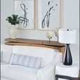 Rustic console table behind white couch with abstract black and white artwork above