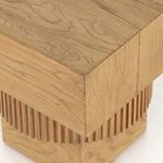Close-up showing mitered corner joinery and wood grain on the table’s square top