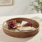 Burma rattan tray styled with grapes, cheese, crackers on a light stone surface in natural sunlight