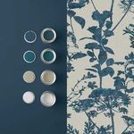 Esther Wallpaper shown beside coordinated paint color samples on deep blue painted wall