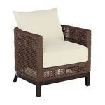 Outdoor barrel chair shown from slightly angled front with cream cushions on dark brown woven raffia frame and wooden legs