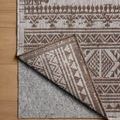 Easton Dove side rug corner flipped to show underside non-slip rug pad in indoor setting
