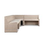 L-shaped vintage white outdoor dining banquette in rattan with fabric cushions and soft curved lines