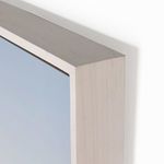 Close-up of the smooth white wooden frame corner with subtle wood grain texture