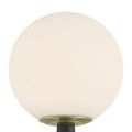 Close-up of frosted glass globe and brass collar atop textured dark gray lamp shaft
