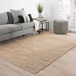 Rug displayed in modern living room setting under sofa, highlighting size and warm earthy tones