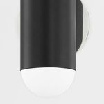 Close-up showing the bottom frosted glass diffuser and smooth black metal body with polished nickel mounting plate