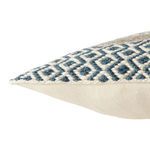Close-up side view showing detailed geometric embroidery and boucle texture on pillow corner