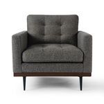 Front view highlighting the symmetrical tufting on backrest and seat cushion