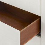 Open bottom drawer interior showing natural wood finish inside sand white dresser