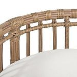 Close-up showing wicker woven top rail and partial cushion in cream fabric