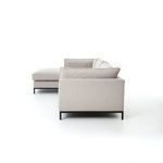 Sectional sofa side view with chaise on left showing armrest and cushions