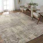 Gravity rug styled in bright room with wooden floor, paired with mid-century modern chairs and small table