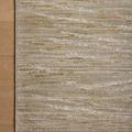 Wade Sage Gold rug styled on light wood floor, showing color gradient and linear pattern