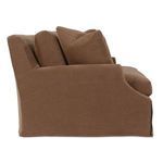 Right profile of sofa showing smooth slipcover fabric and stacked back cushions