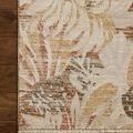 Partial top-down view showing corner of rug laid on wooden floor with fringe edge