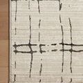 Corner of Darby Sand / Dk. Grey rug on hardwood floor highlighting ribbed texture and edge stitching