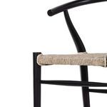 Close-up of armrest tip and backing V brace on black teak frame with woven seat