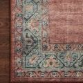 Detailed close-up of the muted aqua floral border on the Heidi Spice Aqua Rug against a wood floor