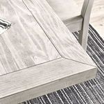 Close-up of the table's plank-style tabletop and wood grain texture with beveled edge
