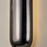 close-up of upper section of black nickel sconce with light softly glowing behind it