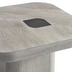 Close-up of tabletop showing detailed wood grain and black leaf-shaped inset pattern