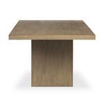 View of Matthes Dining Table from the end showing wood grain on the base and tabletop edge