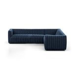 Three-quarter front view from low angle showing plush cushions and navy velvet texture