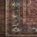 Detailed section of Layla Brick rug border highlighting blue and red patterns on hardwood