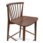 Close-up angled view showing smooth walnut grain on seat and back spindles