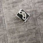 Overhead shot of rug with decorative books and modern white sculpture on top