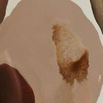 Close-up detail of light beige and brown watercolor area showing granular texture on paper