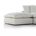 Close-up of ottoman cushion showing soft feather-blend filling and fabric texture