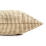 Side view showing the pillow cover’s stitched seams and thickness in beige and white gingham