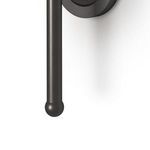 Close-up of bottom part of Jameson Sconce’s long black metal rod with rounded end