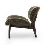 Profile side view highlighting chair’s curvature and dark wooden frame supporting seat and back