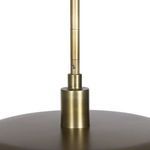 Close-up showing rounded edge transition from aged brass shade to white glass diffuser