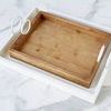 White Bianca Rectangle Tray nesting a smaller natural wood tray inside, highlighting size contrast and handles