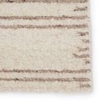 Macro close-up emphasizing dense wool fibers and natural color flecks within the brown stripes