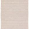 Handwoven outdoor rug with diamond trellis pattern in tan and cream featuring a subtle distressed look