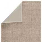 Back side of Sutton Natural Solid area rug showing beige canvas backing with folded corner