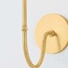 Close-up of aged brass J-arm with detailed Victorian metalwork and wall mounting plate