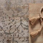 Close-up of textured vintage rug surface and ornate traditional design in soft muted colors