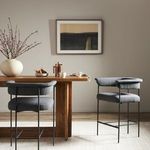 Heel and footrest section of bar stool showing sleek black metal frame